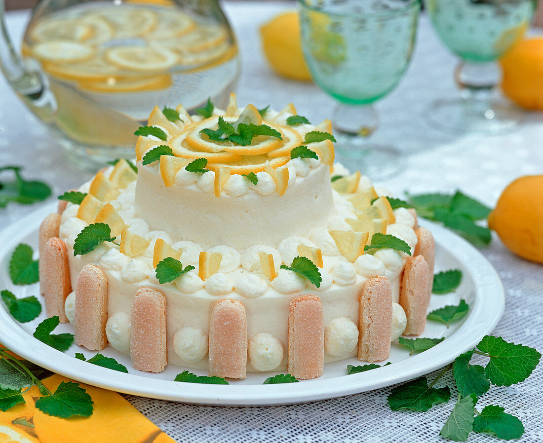 Cake decorated with lemon pieces and lemon balm