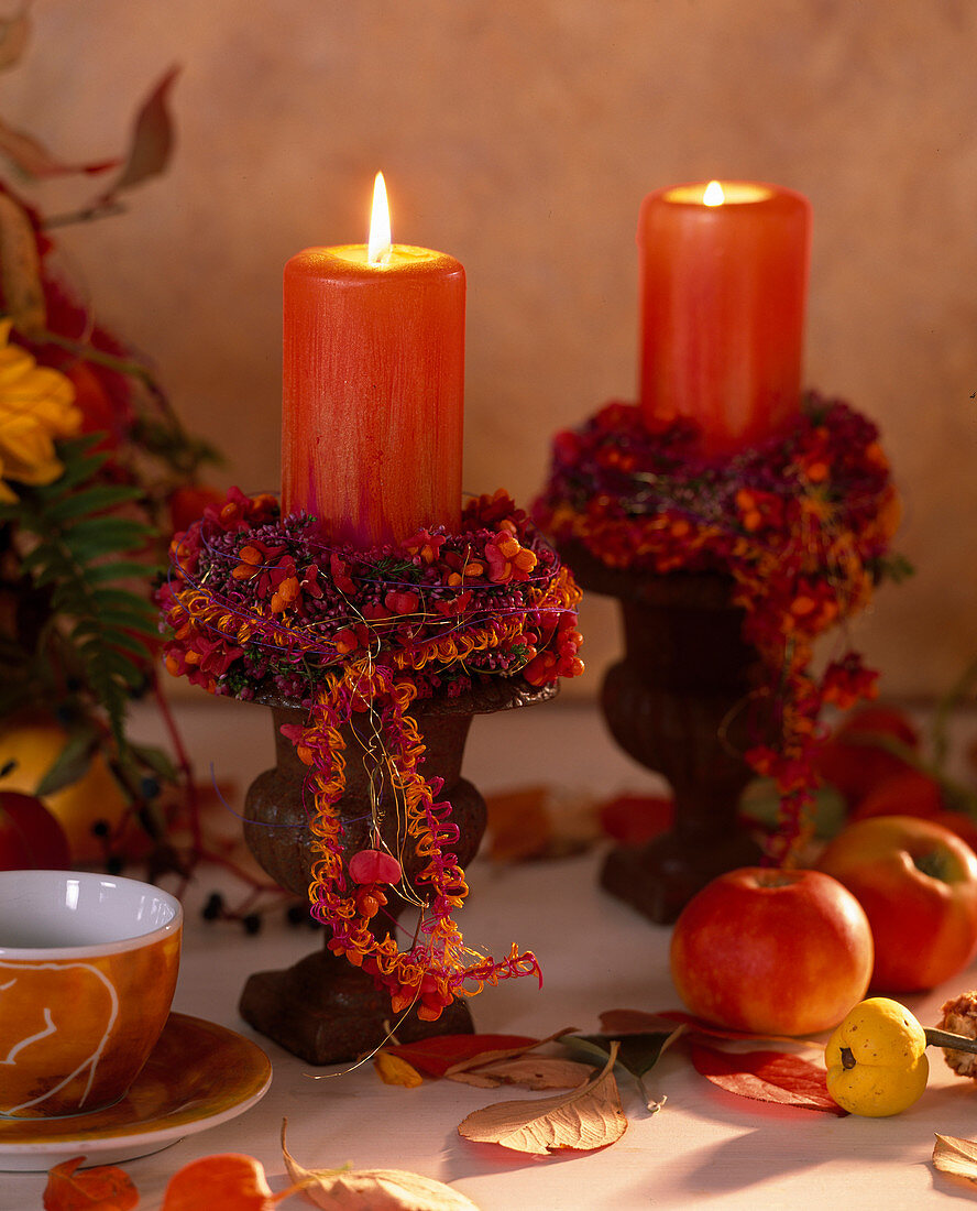 Candles in iron decorated with Euonymus (spindle tree)