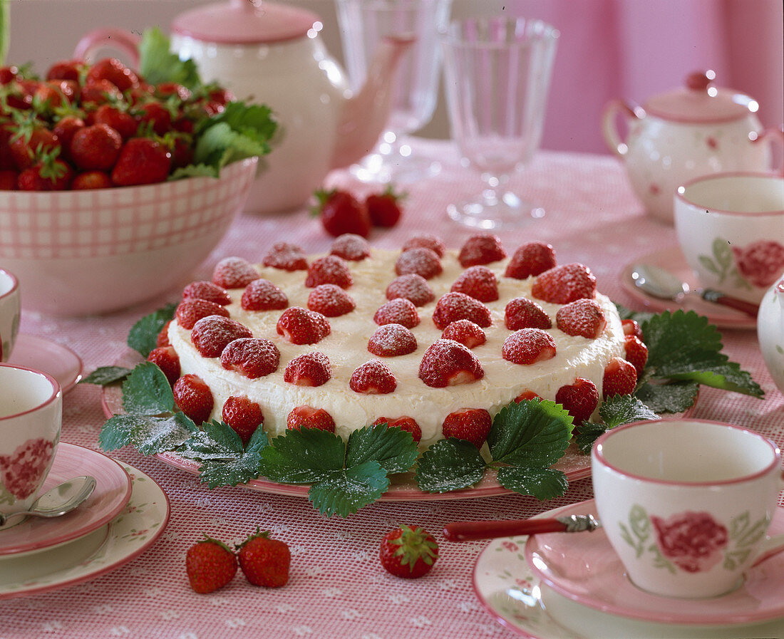 Strawberry cake decorated with fruits and leaves