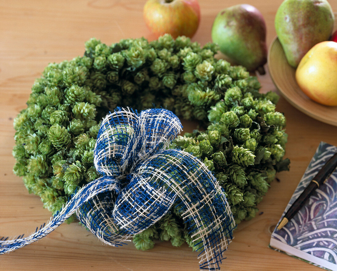 Wreath of hop cones tied and decorated with a bow