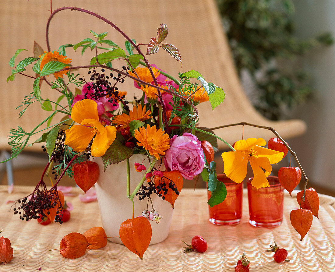 Autumn arrangement : Rosa (roses and rose hips), Calendula (marigolds), Eschscholzia