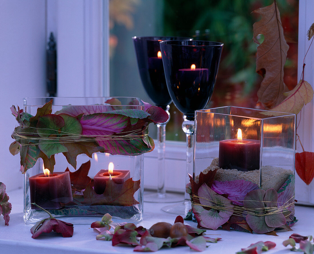 Glass vases decorated as lanterns with Brassica (ornamental cabbage), Hydrangea (hydrangea)