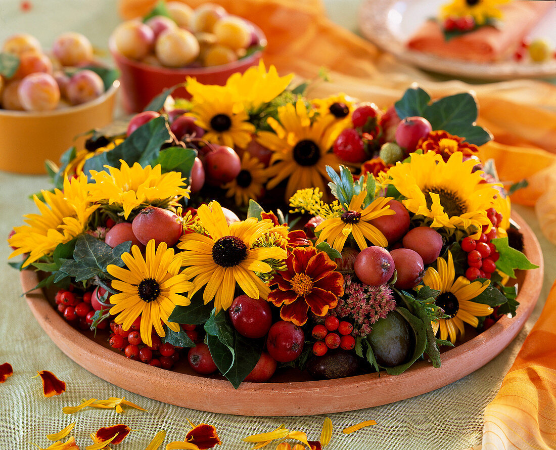 Plate wreath on coaster: coneflower, crab apples, rowan berries and stonecrop