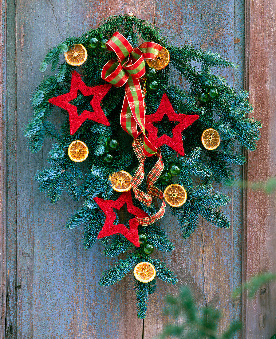 Door arrangement of nobilis branch, sisal stars, orange slices and ribbon