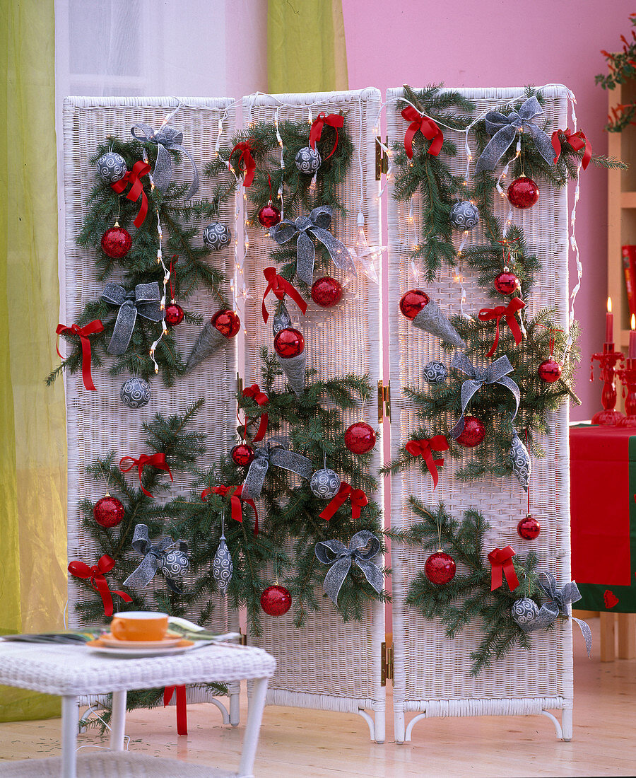 Christmas screen: Picea (spruce branches), red and silver bows, baubles