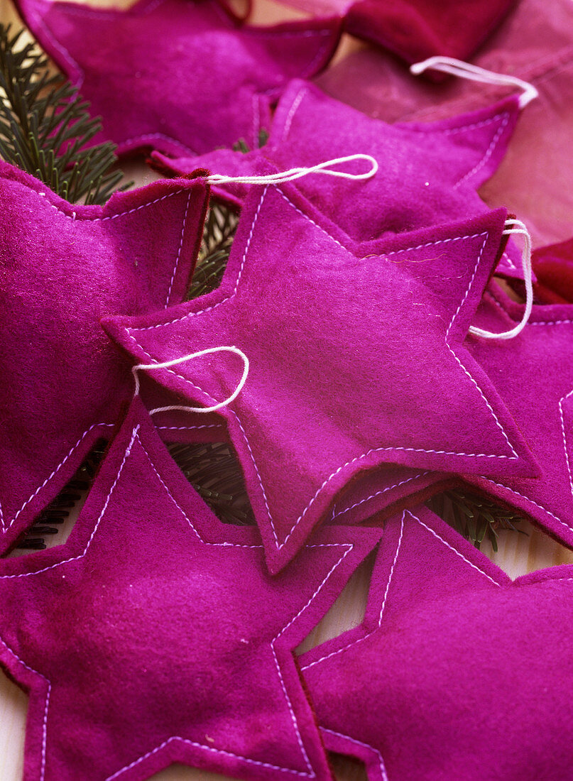 Stars sewn from felt as Christmas tree decorations, purple-pink