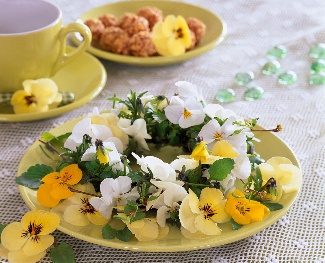 Plate wreath of flowers of violets and birch branches