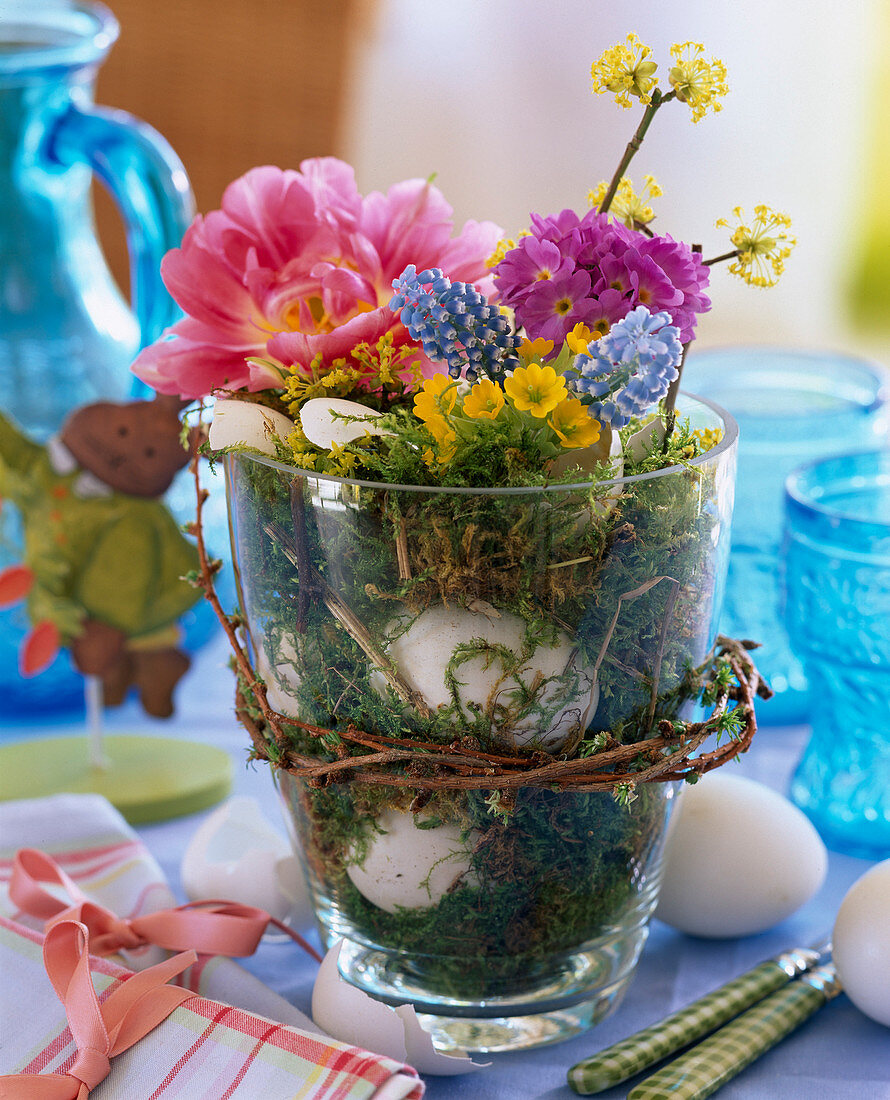 Glass vase with moss and eggs, eggshells as vases