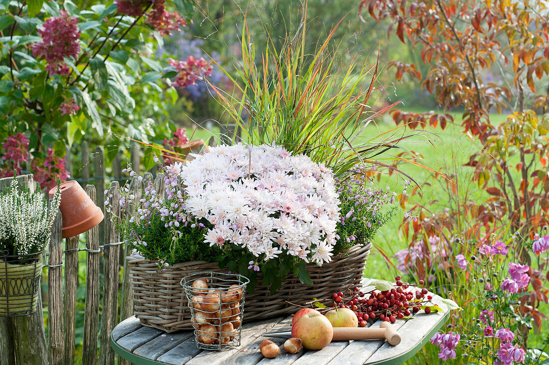 Autumn arrangement on table at the garden fence
