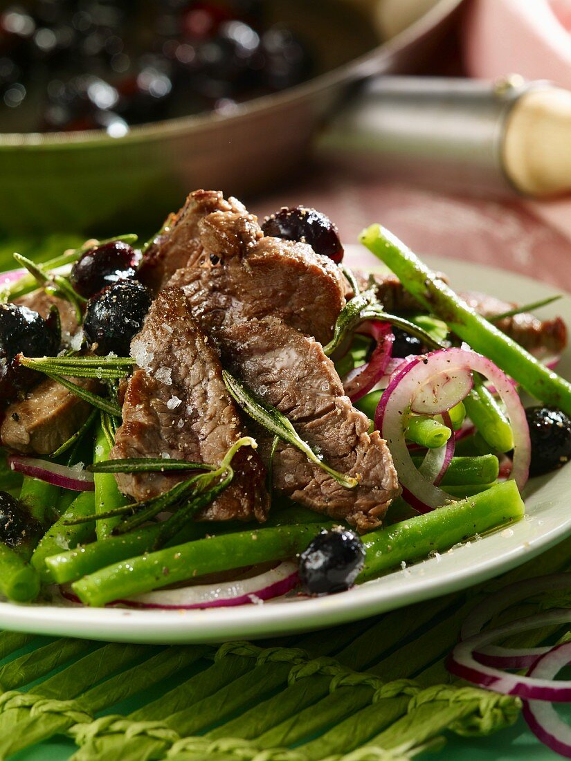 A beef fillet with blueberries and a bean salad