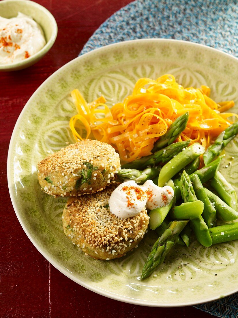 Lentil meatballs with carrot noodles, asparagus and lime cream