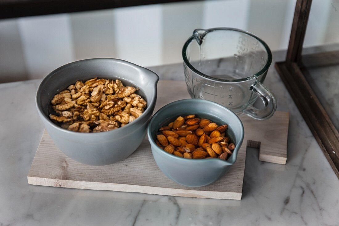 Walnuts and almonds being soaked in water (raw baking)