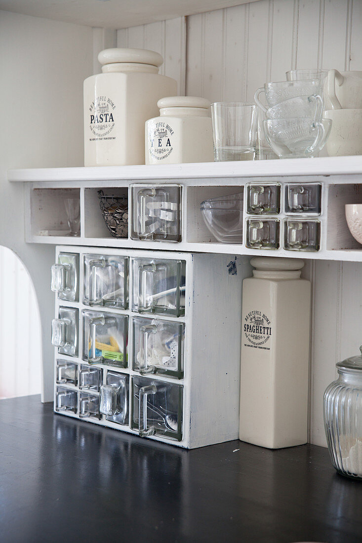 Kitchen shelves with glass drawers and storage jars