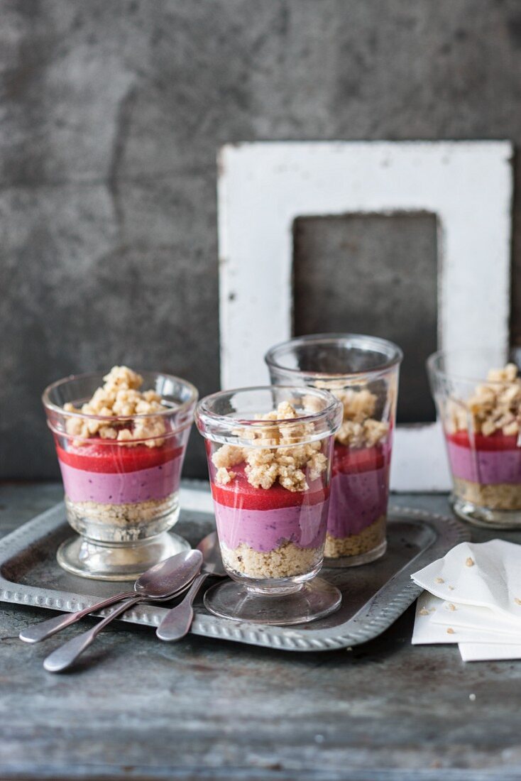 Vegan berry cakes in a glass with a nut crumble topping