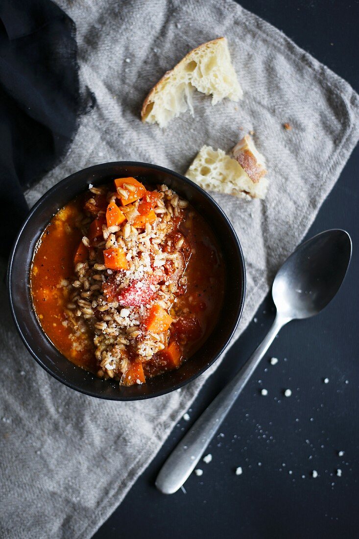 Tomato soup with farro, carrot and parmesan cheese