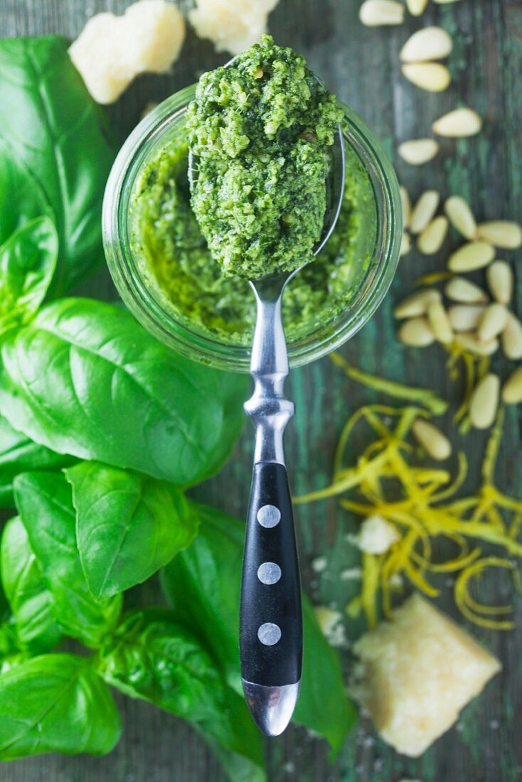 A spoon of lemon pesto on a preserving glass jar with a spoon