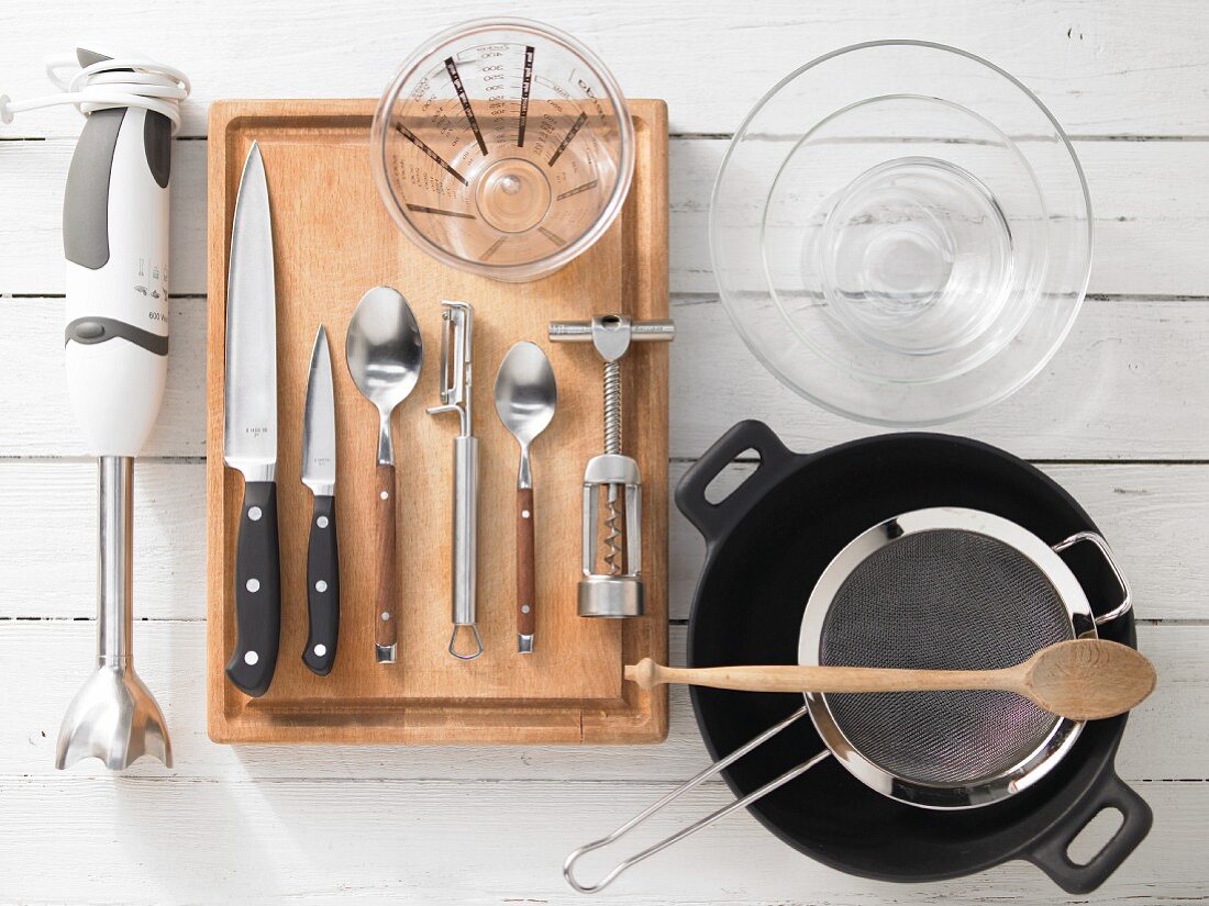 Kitchen utensils for making a fish curry served in a coconut