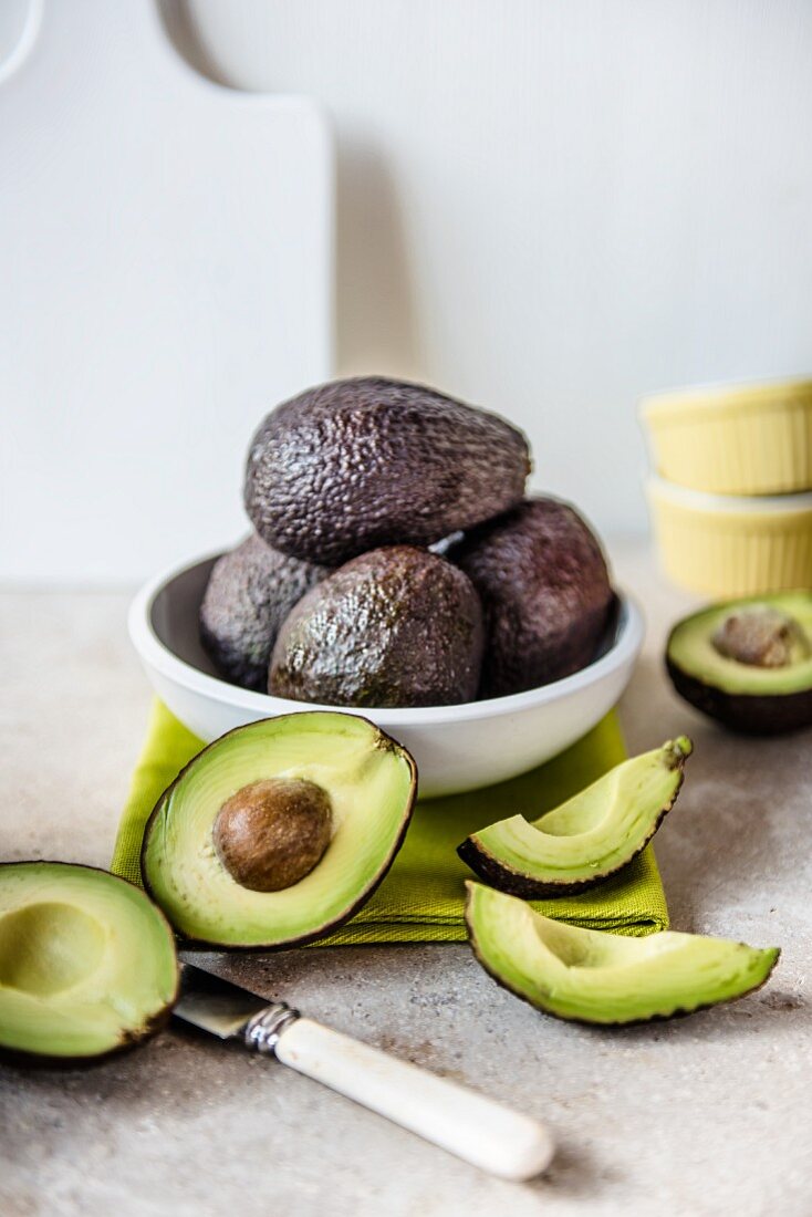 Fresh whole and sliced avocados