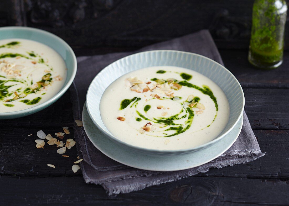 Creamy parsnip soup with almond flakes and parsley oil