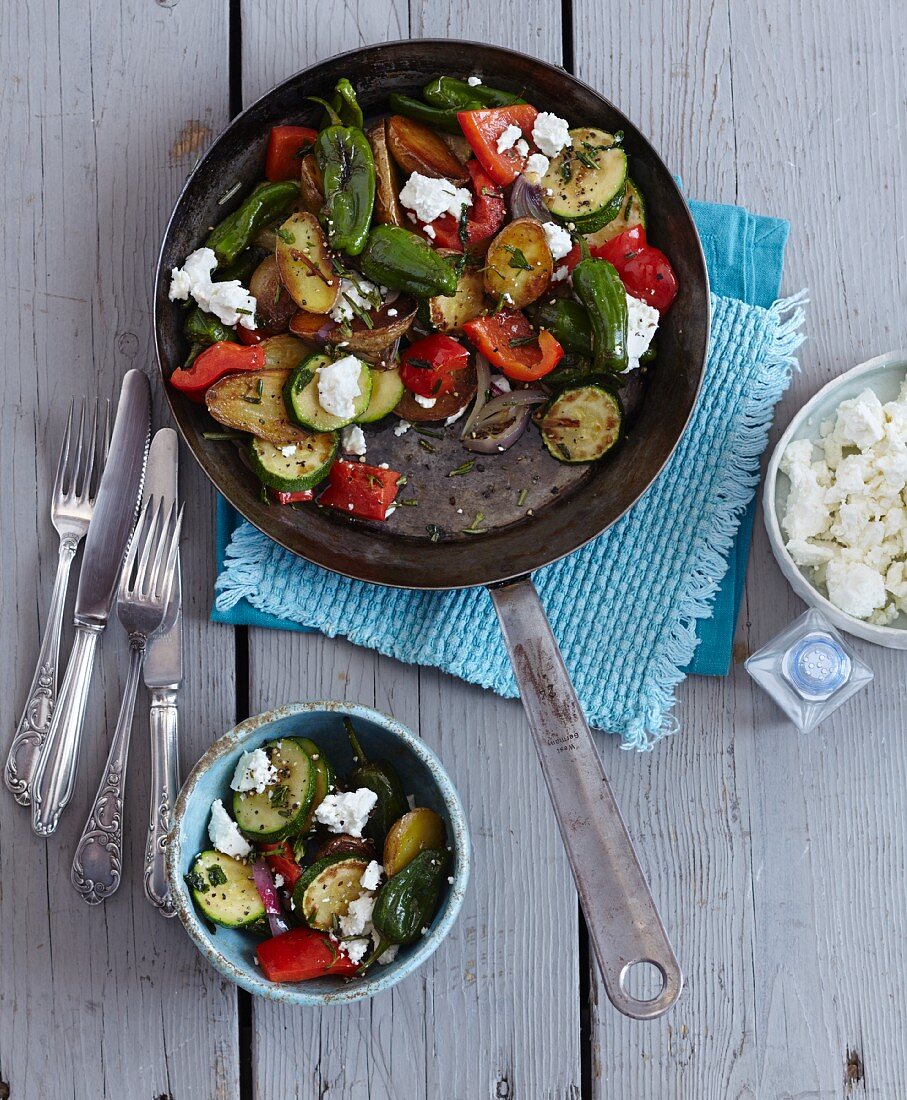 Vegetarian potato and vegetable pan-served dish with feta