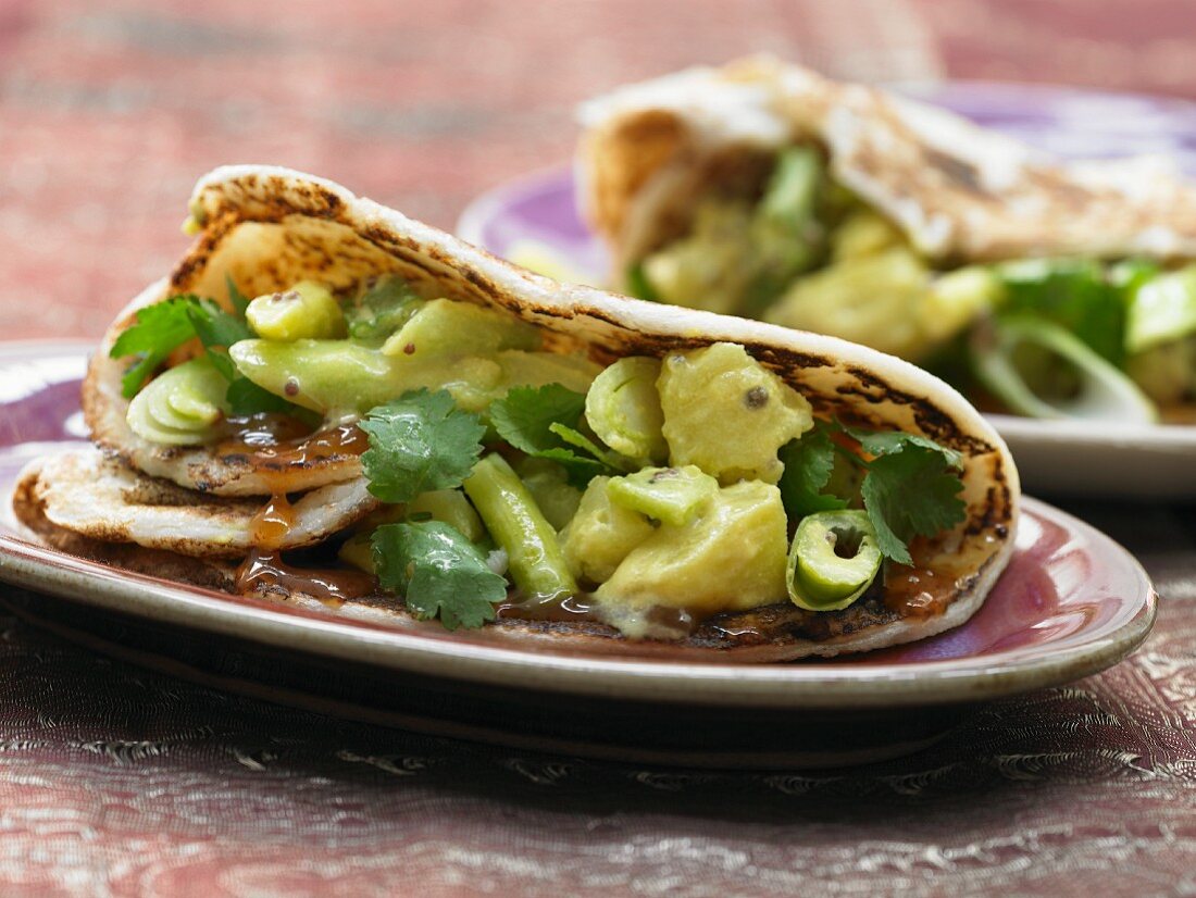 Masala dosa (Indian pancake) with coconut potatoes and spring onions