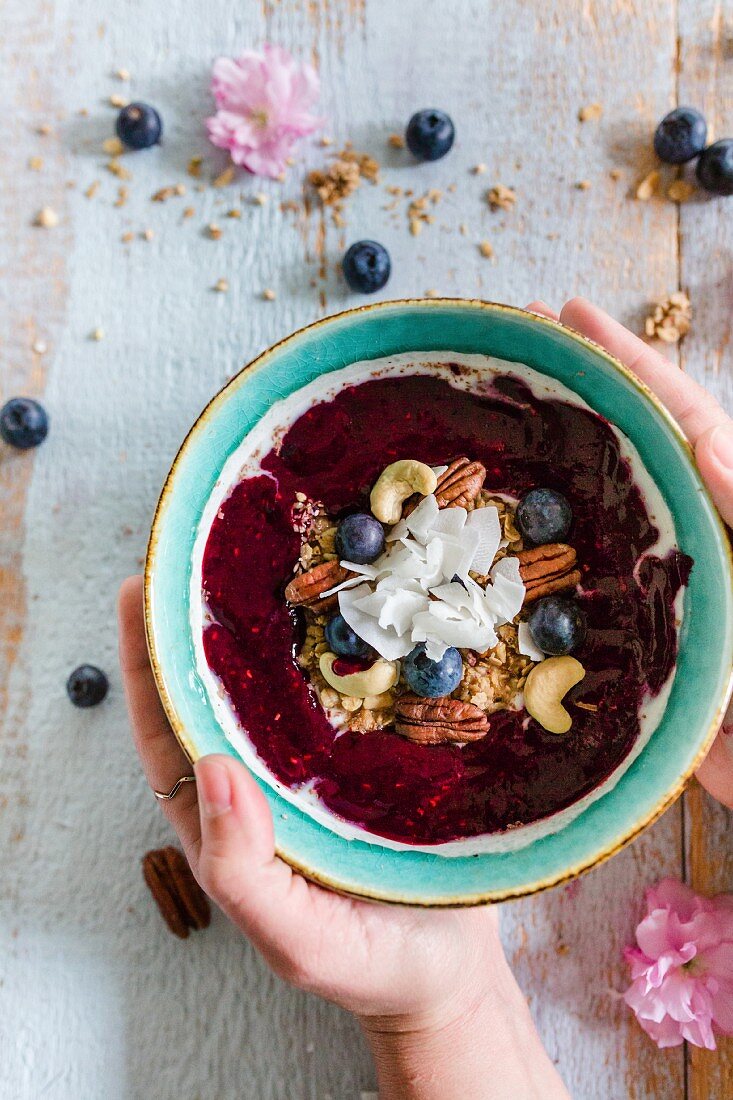 A smoothie bowl with berries and nuts