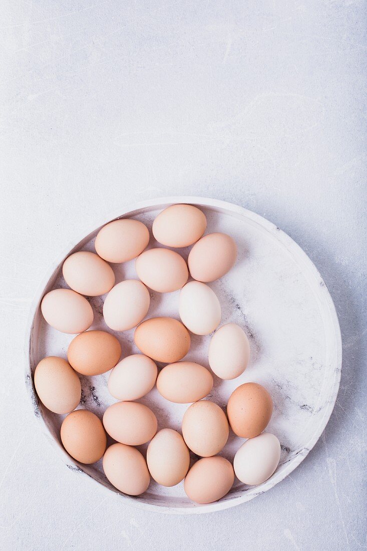 Fresh eggs on a grey marble tray