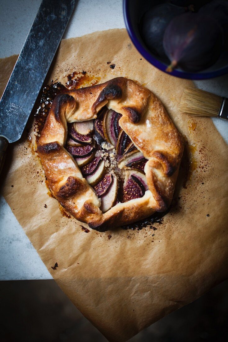 Shortcrust sweet pastry galette, folded and filled with ground almonds and thin slices of fresh pear, fig and with a vanilla sugar crust