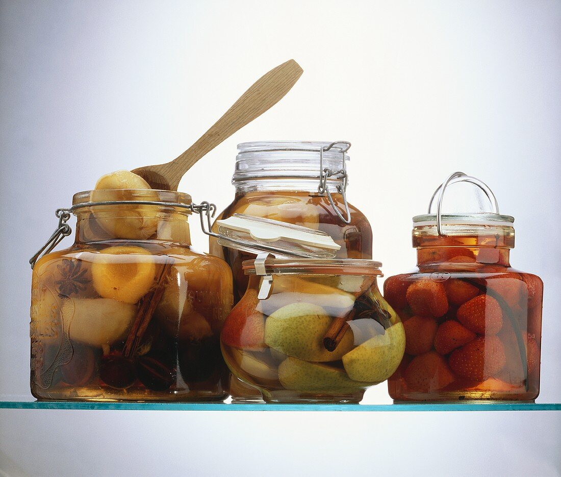 Four Jars of Preserved Fruit; Wooden Spoon
