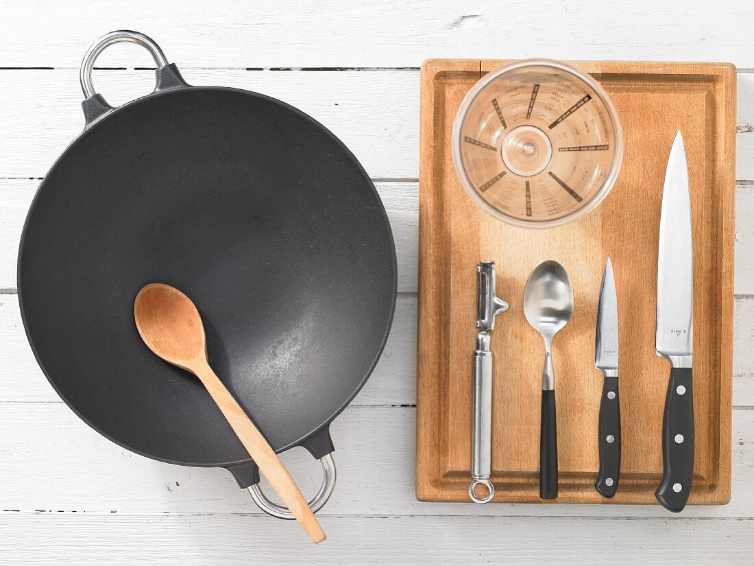 Kitchen utensils for making sweet and sour prawns with mango and peppers in a wok