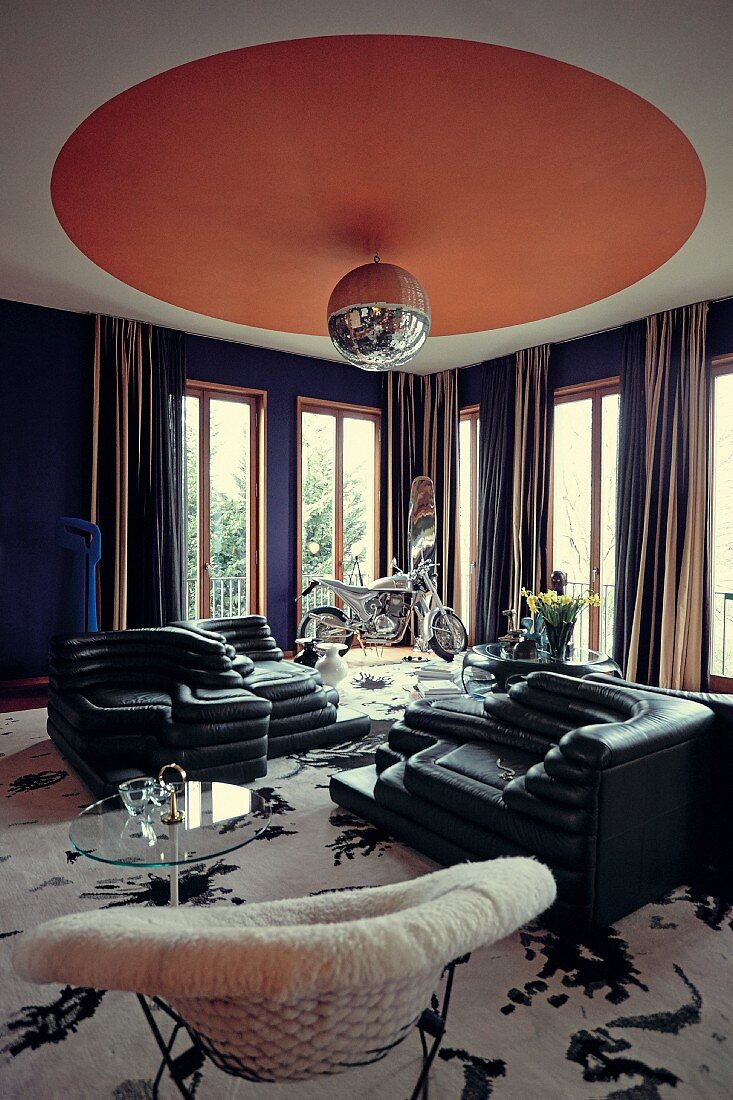 An extravagant living room with designer furniture and a disco ball