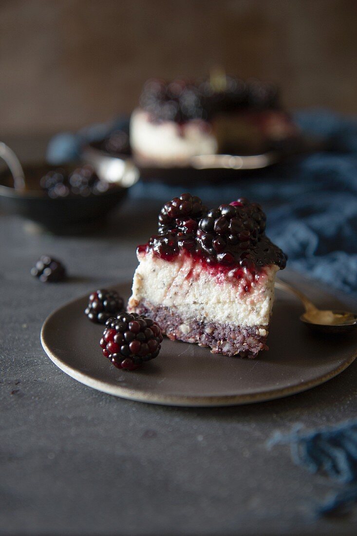 A piece of cheesecake with blackberries
