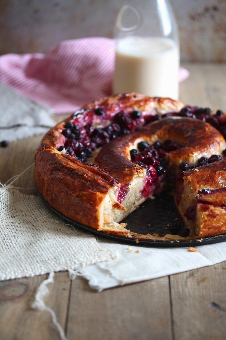 Cherry yeast cake with a slice cut out