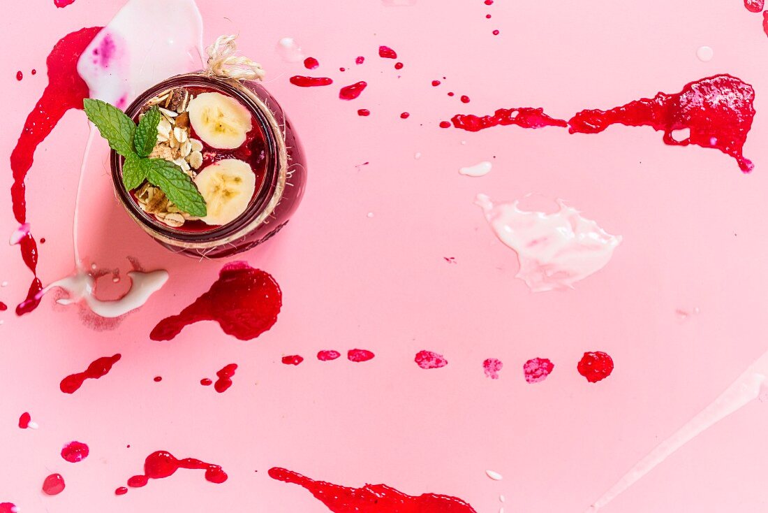 Beet soup in a white bowl on colored construction paper surface - healthy food