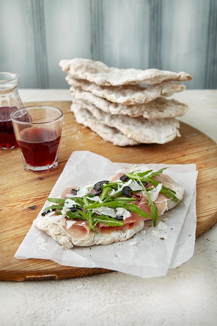 Focaccia with ham, rocket, parmesan and olives