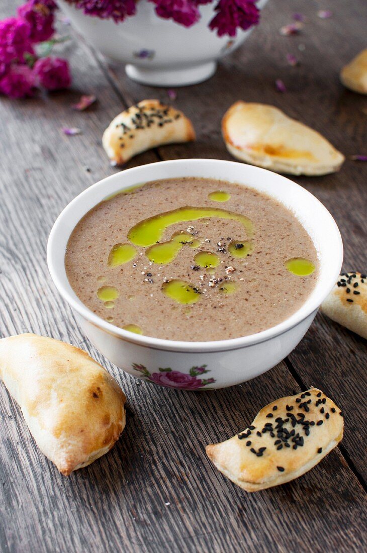 Cream of mushroom soup topped with truffle oil and freshly ground pepper, served with little pastry parcels
