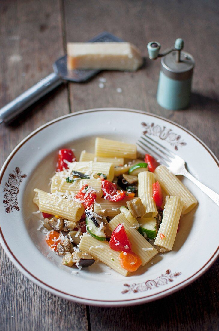 Rigatoni ortolana. Pasta with vegetables (zucchini, eggplant, red pepper, carrot, tomatoes, garlic and onion). Served with grated parmesan cheese and freshly ground black pepper