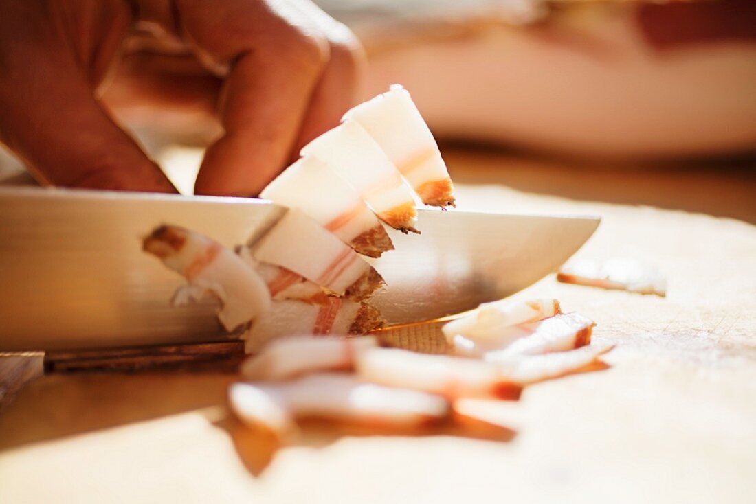 Bacon being chopped into small pieces at the Hofmanufaktur Kral in South Tyrol