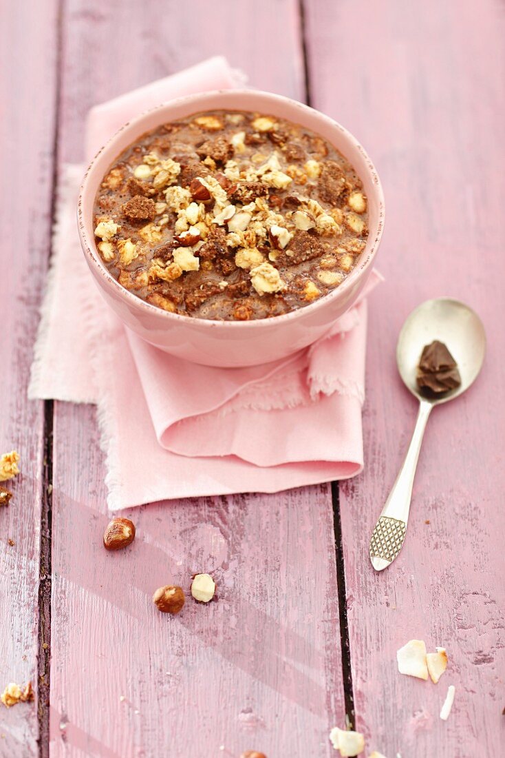 Chocolate milk soup with granola, hazelnuts and chocolate biscuits