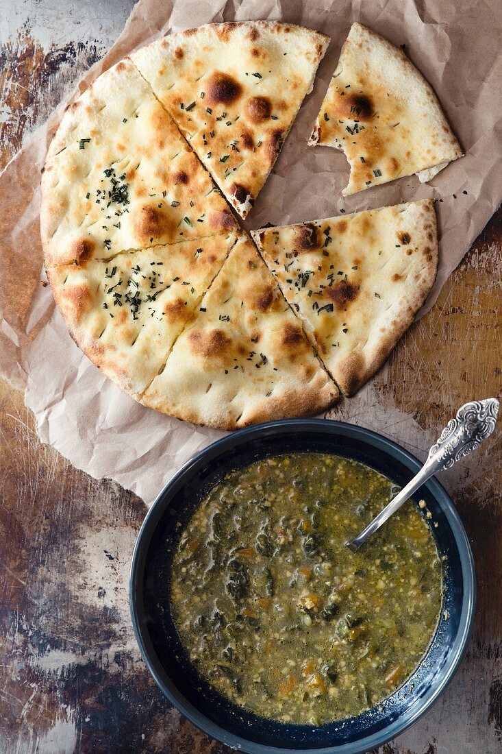 Spinach soup and a flatbread (seen from above)