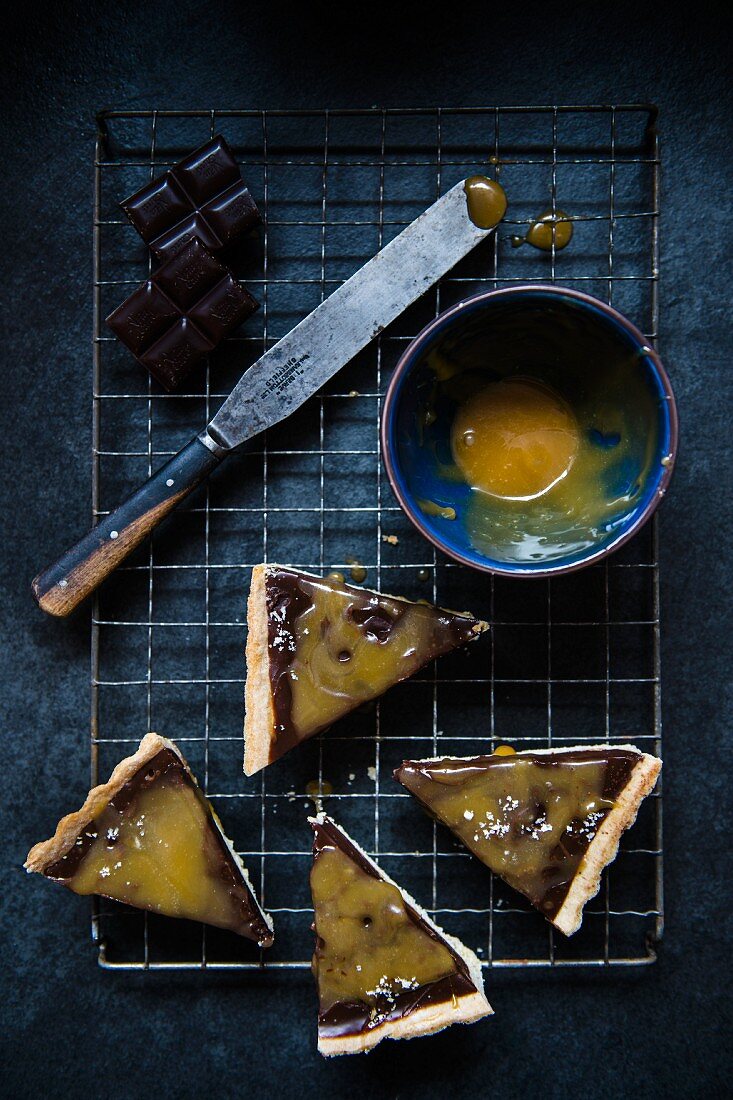 Four slices of chocolate and salted carmel tart (seen from above)