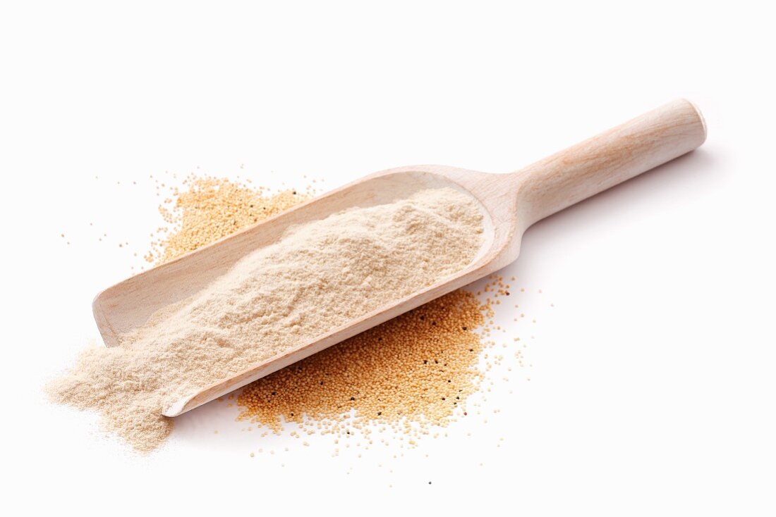 Quinoa flour on a wooden scoop