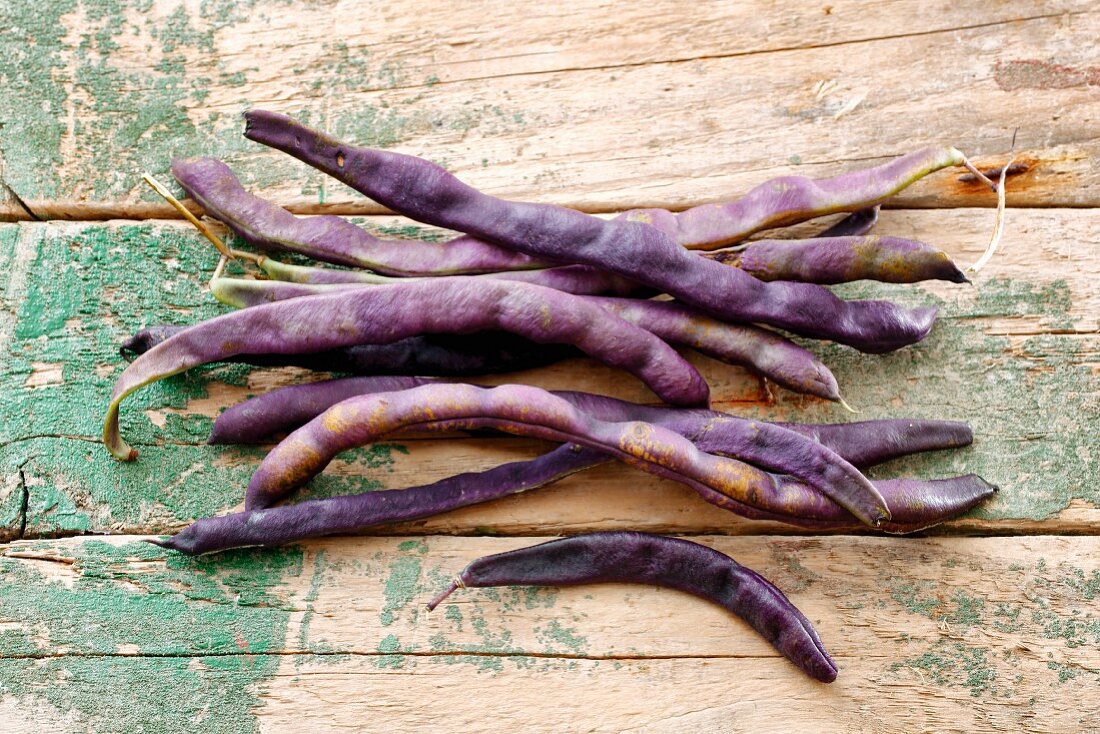 Purple beans on a wood background