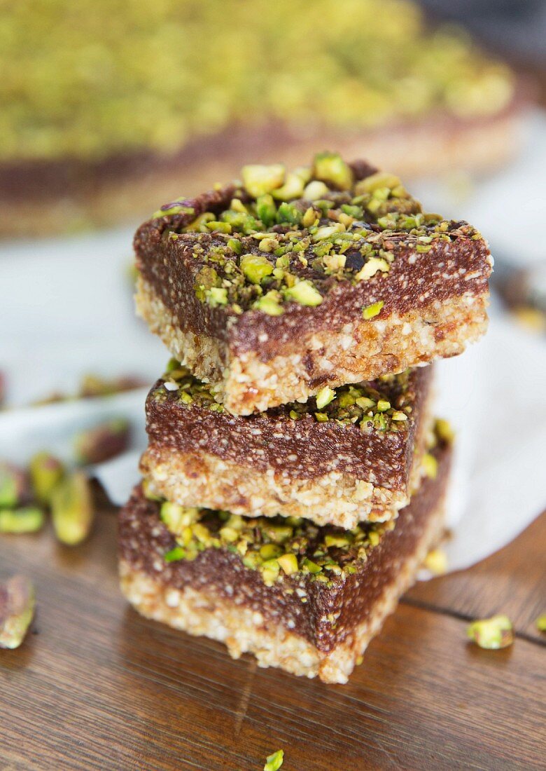 A stack of pistachio and chocolate slices