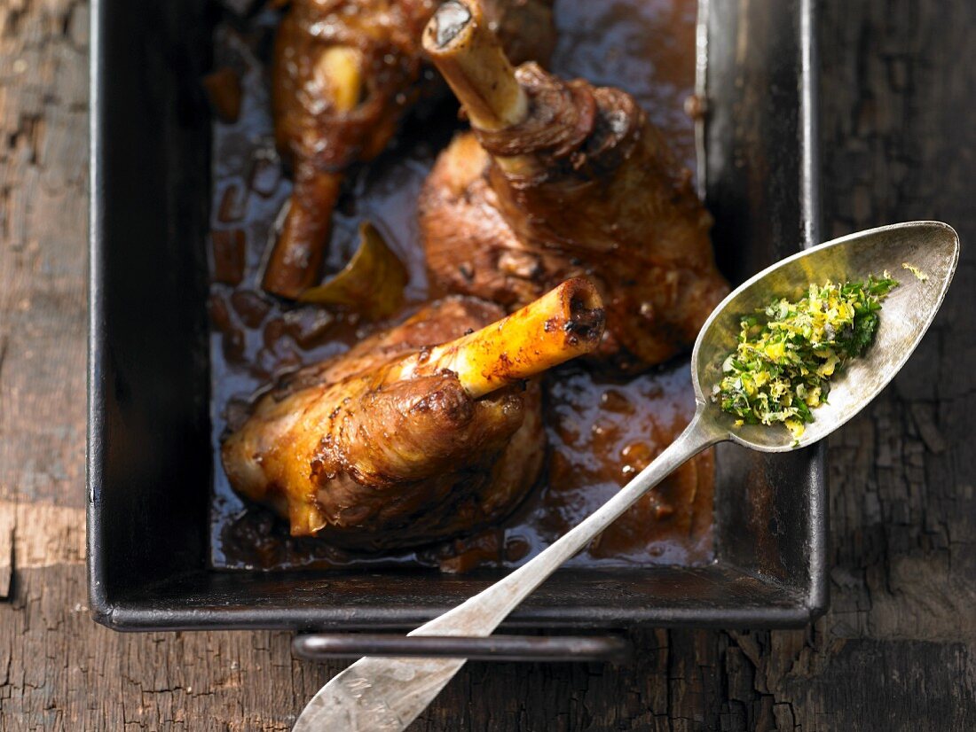 Braised lamb shanks with red wine, herbs and garlic