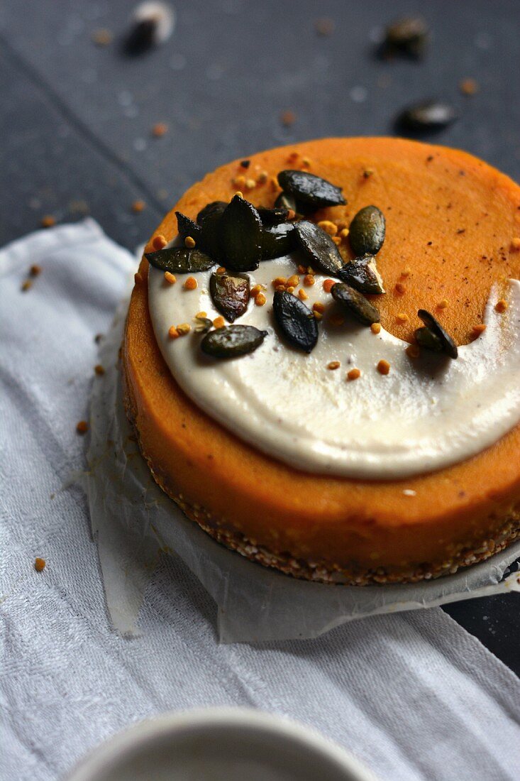 Vegan pumpkin cake with cashew cream and caramelised pumpkin seeds