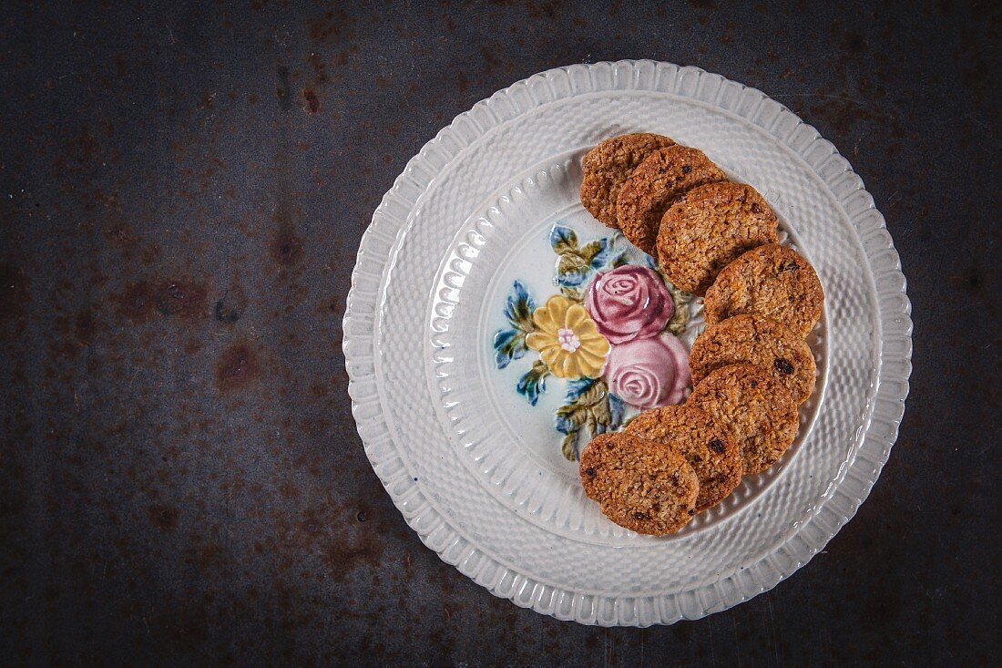Oat, coconut and goji berry cookies arranged on a plate