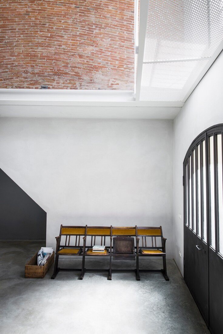 Vintage cinema chairs next to entrance door in loft apartment