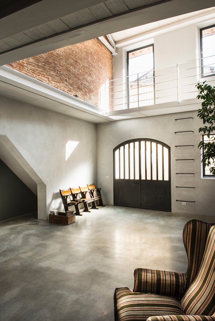 Concrete floor in bright foyer of loft apartment