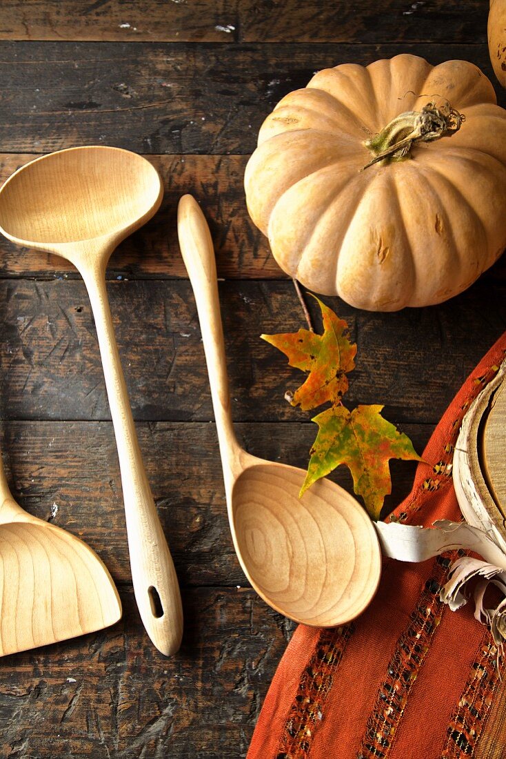 Fall diner celebration in the country, wooden spoons with leaves and pumpkin
